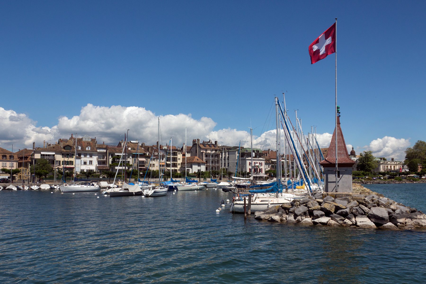 Morges harbour on Lake Geneva with the Swiss flag — a destination wedding region