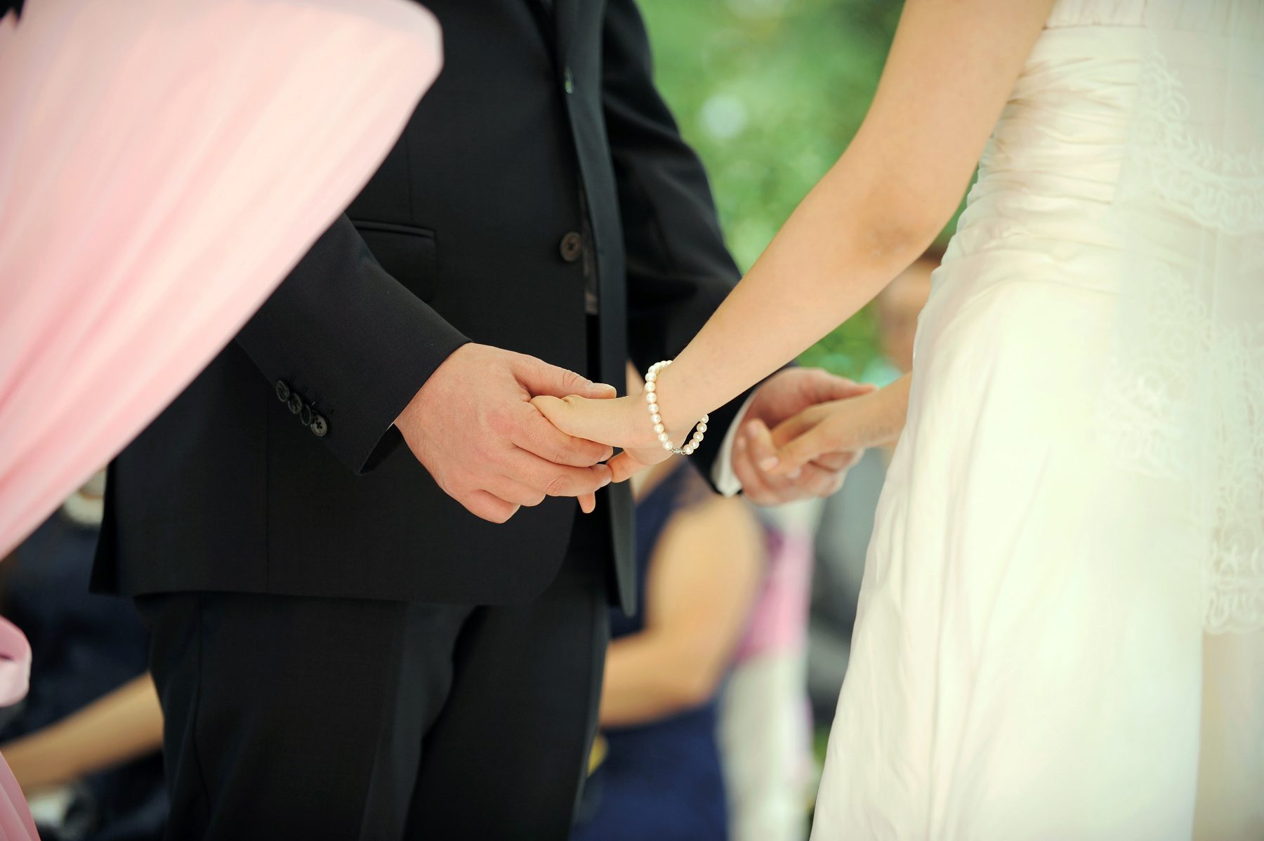 Bride and groom holding hands during their wedding ceremony